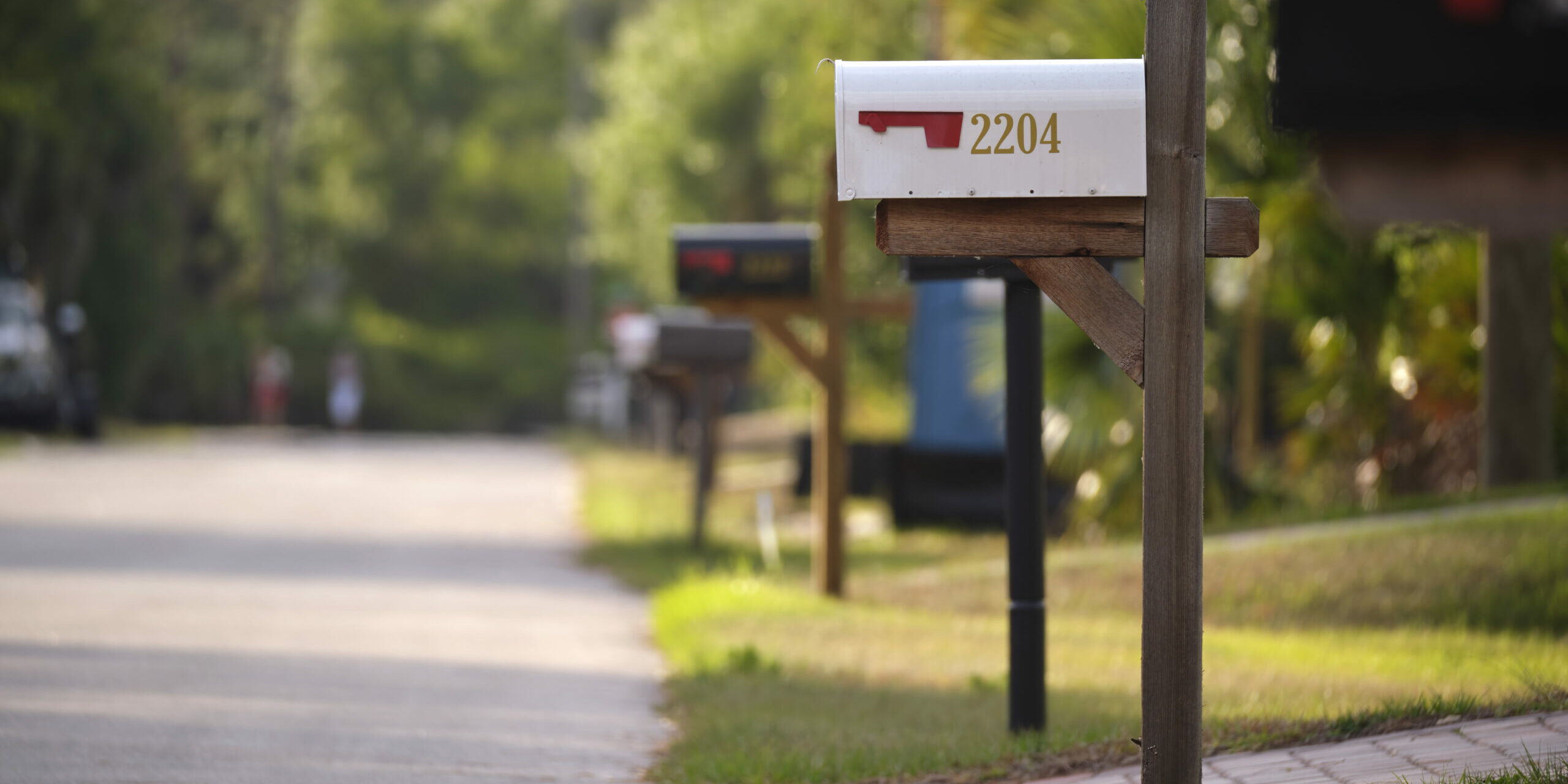 Typical american outdoors mail box on suburban street side.